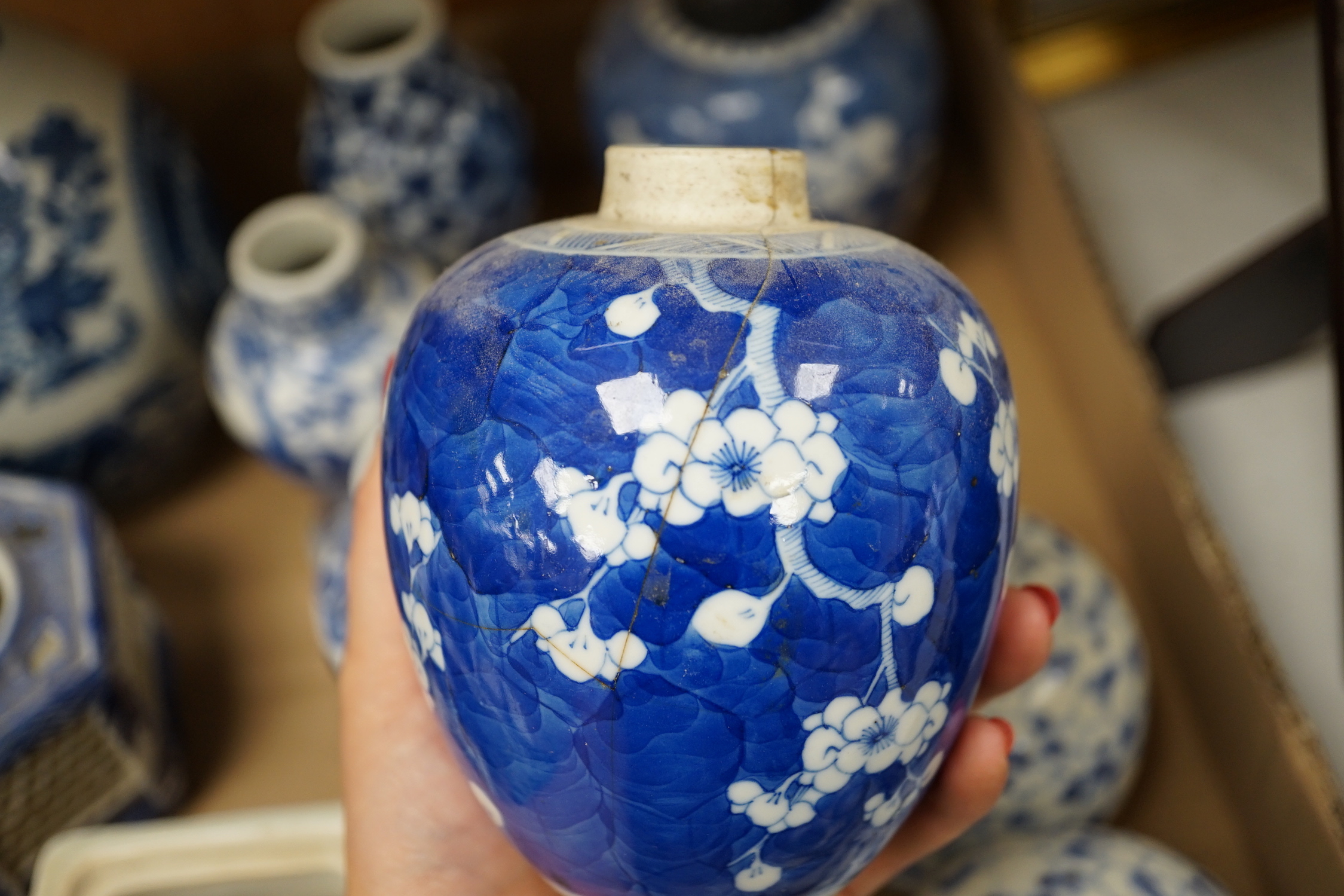 A collection of 18th - early 20th century Chinese blue and white porcelain vases, jars and spare covers, together with some Japanese blue and white ceramics, tallest 21cm